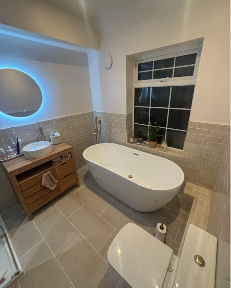 Modern bathroom renovation in Dudley with freestanding bath and grey tiling by Running Plumbing
